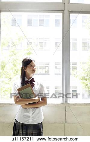 Stock Image - Schoolgirl by Window. Fotosearch