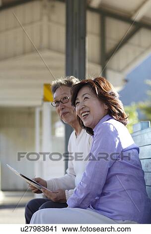 Stock Image - Senior Couple at Rail Station. Fotosearch