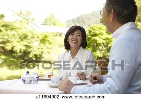 Stock Image - Senior Couple Having Afternoon Tea. Fotosearch