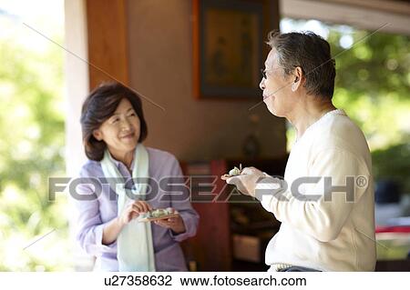Stock Image - Senior Couple Having Kuri Kinton. Fotosearch