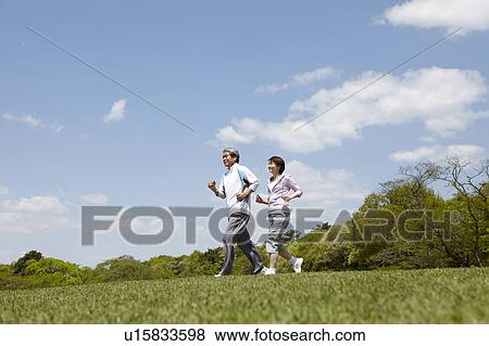 Stock Photo - Senior Couple Jogging in Park. Fotosearch