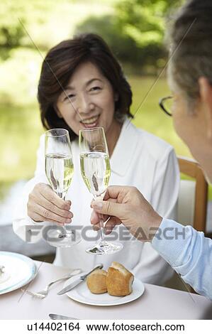 Picture - Senior Couple Toasting With Champagne. Fotosearch
