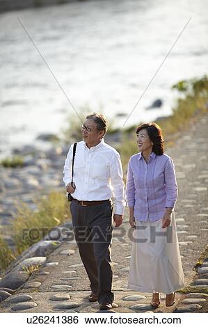 Senior Couple Walking by River View Large Photo Image Stock Photograph - Senior Couple Walking by River. Fotosearch
