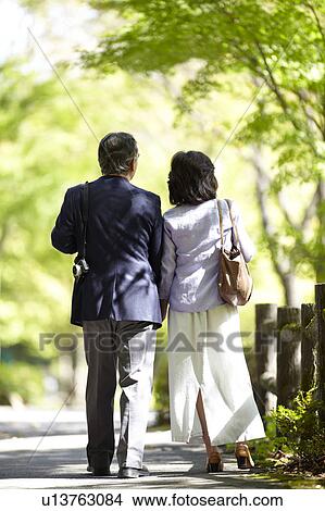 Picture - Senior Couple Walking in Park. Fotosearch