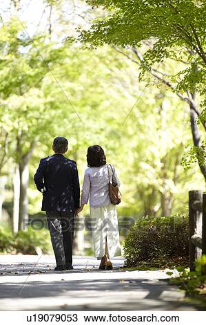 Senior Couple Walking in Park View Large Photo Image Stock Image - Senior Couple Walking in Park. Fotosearch