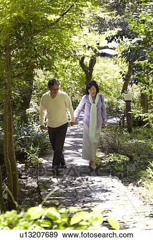 Stock Photo - Senior Couple Walking on Path. Fotosearch