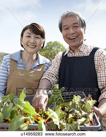 Stock Image - Senior Couple with Seedlings. Fotosearch