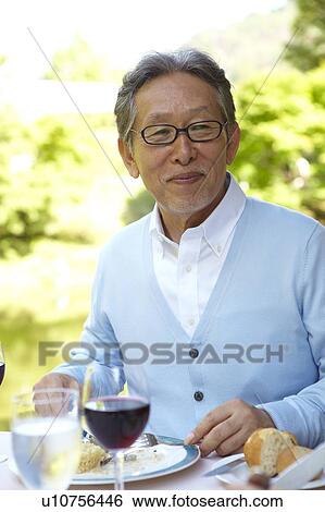 Stock Photograph - Senior Man Having Lunch. Fotosearch