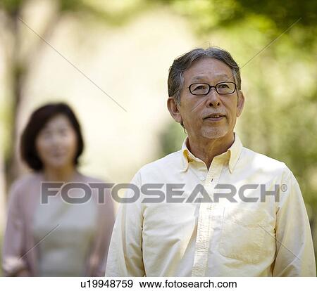 Stock Photo - Senior Man with Wife in Background. Fotosearch