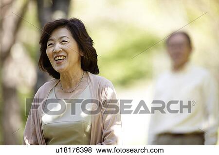 Senior Woman with Husband in Background View Large Photo Image Stock Photo - Senior Woman with Husband in Background. Fotosearch