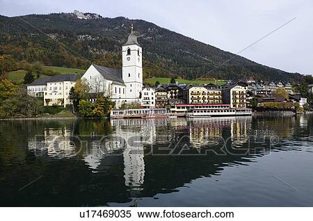 Stock Photography - St Wolfgang and Church Reflected in Lake. Fotosearch