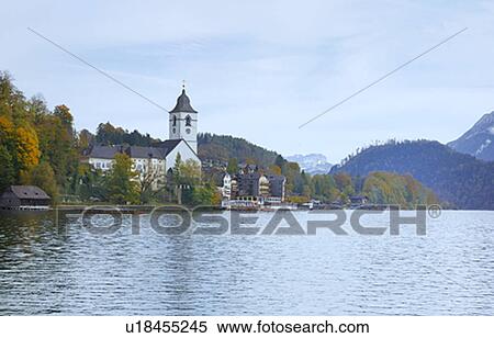 Stock Photography - St Wolfgang and Church Reflected in Lake. Fotosearch