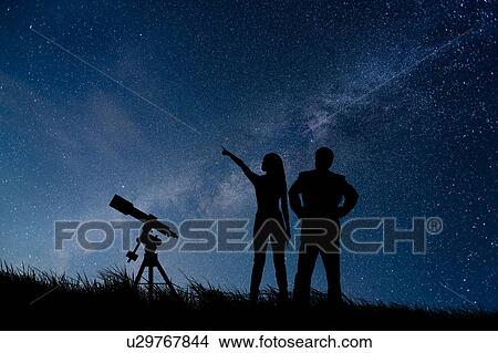 Picture - Starry Sky and Silhouette of People. Fotosearch