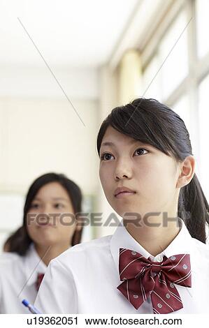 Stock Image - Teenage Girl in Classroom. Fotosearch