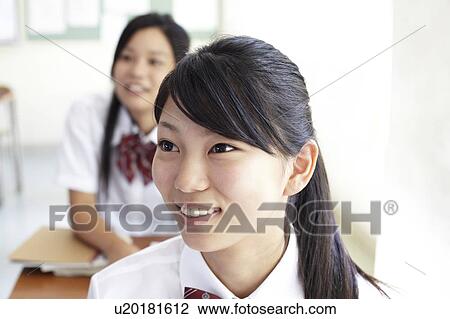 Stock Image - Teenage Girl in Classroom. Fotosearch