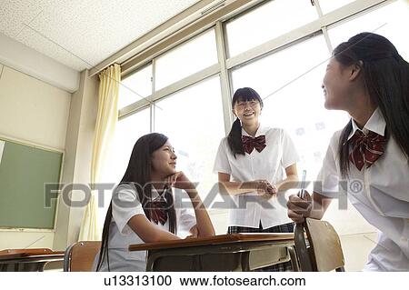 Stock Image - Three Female Students Talking. Fotosearch