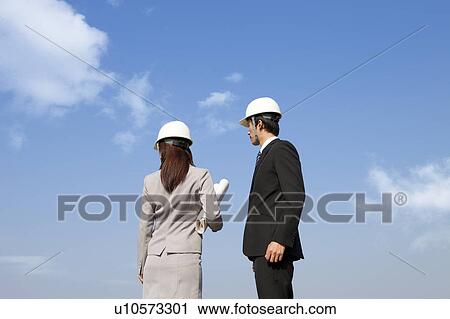 Stock Image - Two Businesspeople at Construction Site. Fotosearch