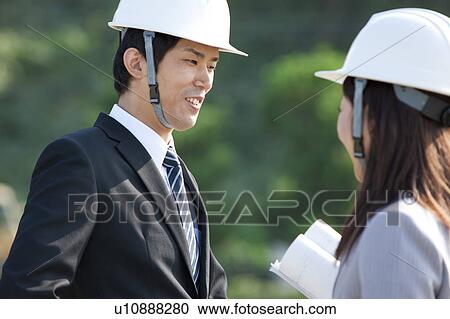 Stock Image - Two Businesspeople at Construction Site. Fotosearch