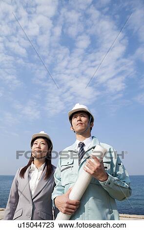 Stock Image - Two Businesspeople at Construction Site. Fotosearch