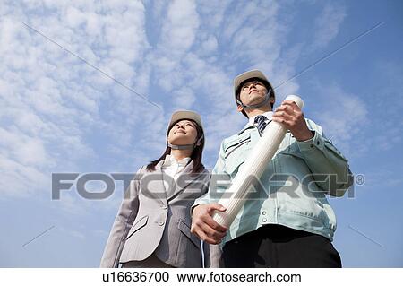 Stock Image - Two Businesspeople at Construction Site. Fotosearch