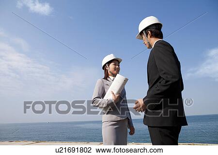 Stock Image - Two Businesspeople at Construction Site. Fotosearch
