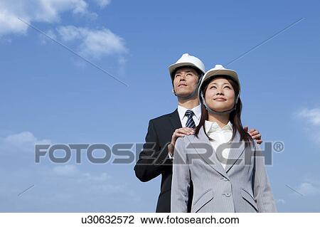 Stock Image - Two Businesspeople at Construction Site. Fotosearch