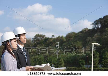 Two Businesspeople at Construction Site View Large Photo Image Stock Photo - Two Businesspeople at Construction Site. Fotosearch