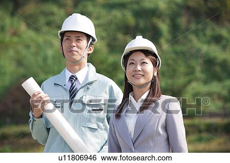 Two Businesspeople at Construction Site View Large Photo Image Stock Photograph - Two Businesspeople at Construction Site. Fotosearch