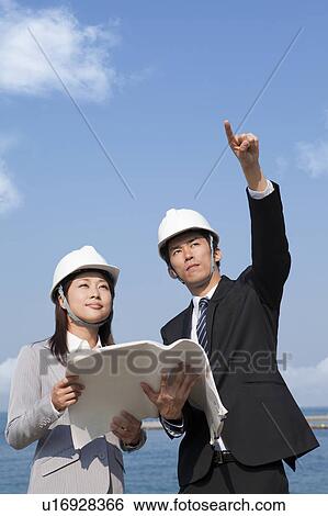 Two Businesspeople at Construction Site View Large Photo Image Stock Photograph - Two Businesspeople at Construction Site. Fotosearch