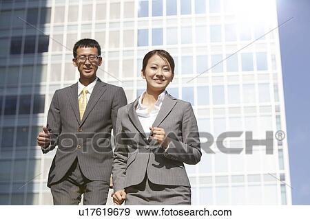 Stock Photo - Two Businesspeople on The Go. Fotosearch