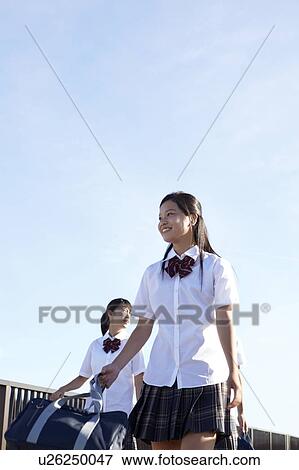 Two Schoolgirls Walking on Bridge View Large Photo Image Stock Photo - Two Schoolgirls Walking on Bridge. Fotosearch