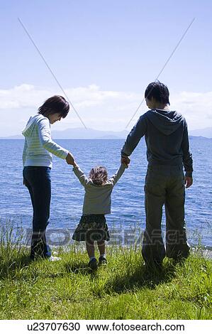 Stock Image - Two Women and Girl Holding Hands. Fotosearch