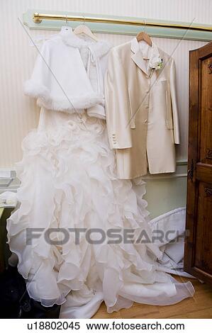 Wedding dress and tuxedo on a hanger View Large Photo Image Stock Photography - Wedding dress and tuxedo on a hanger. Fotosearch