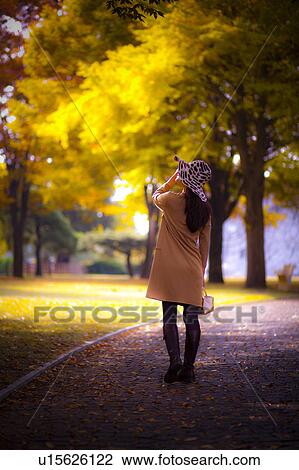 Stock Image - Woman at a park. Fotosearch