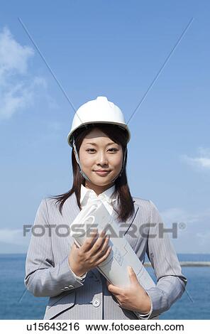 Young Businesswoman with Blueprint and Hardhat View Large Photo Image Stock Photograph - Young Businesswoman with Blueprint and Hardhat. Fotosearch