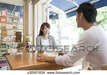 Young couple at a cafe View Large Photo Image Picture - Young couple at a cafe. Fotosearch