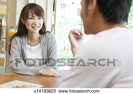 Young couple at a cafe View Large Photo Image Stock Image - Young couple at a cafe. Fotosearch