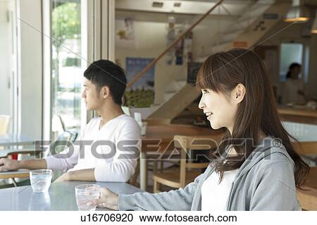 Stock Image - Young couple at a cafe. Fotosearch