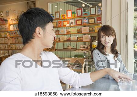 Young couple at a cafe View Large Photo Image Stock Photo - Young couple at a cafe. Fotosearch