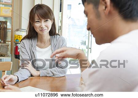 Stock Photograph - Young couple at a cafe. Fotosearch