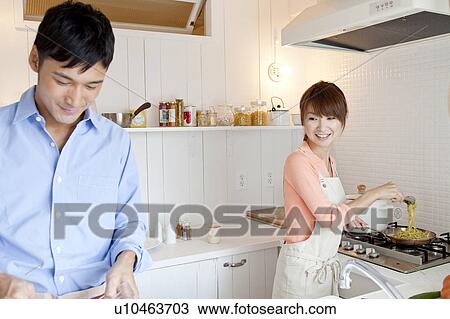 Young couple at kitchen View Large Photo Image Stock Image - Young couple at kitchen . Fotosearch