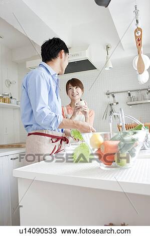 Young couple at kitchen View Large Photo Image Stock Image - Young couple at kitchen . Fotosearch