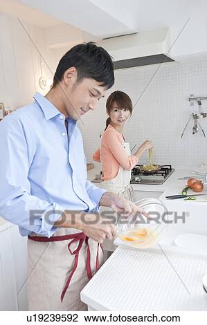 Young couple at kitchen View Large Photo Image Stock Image - Young couple at kitchen . Fotosearch