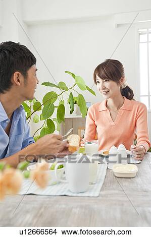 Young couple eating breakfast View Large Photo Image Picture - Young couple eating breakfast. Fotosearch