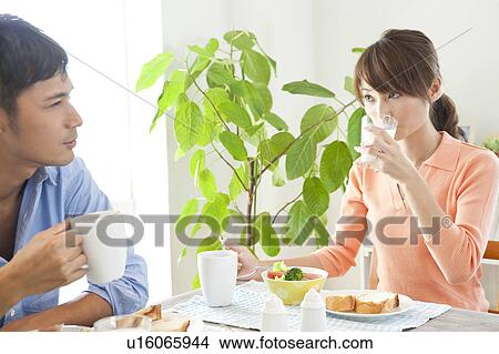 Young couple eating breakfast View Large Photo Image Picture - Young couple eating breakfast. Fotosearch