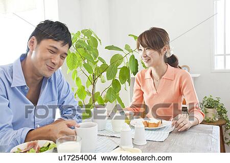 Picture - Young couple eating breakfast. Fotosearch
