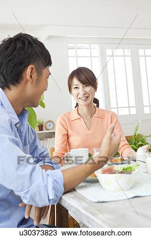 Stock Image - Young couple eating breakfast. Fotosearch