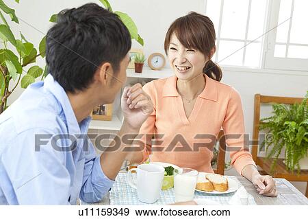 Stock Photo - Young couple eating breakfast. Fotosearch