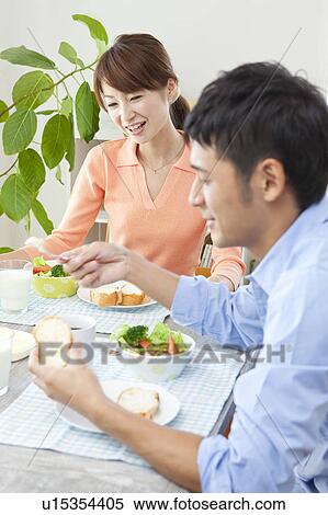 Stock Photography - Young couple eating breakfast. Fotosearch