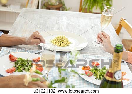 Young couple eating dinner View Large Photo Image Stock Image - Young couple eating dinner. Fotosearch